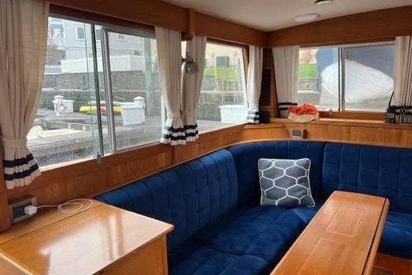 Slide: The Image of Interior of 2000 Grand Banks 36 Classic yacht with blue seating and wooden accents. - 13