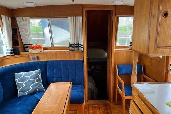 Slide: The Image of Interior of 2000 Grand Banks 36 Classic yacht with blue seating and wooden finishes. - 14