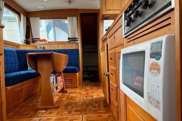 Slide: The Image of Interior of 2000 Grand Banks 36 Classic yacht with wood finish and blue seating. - 15