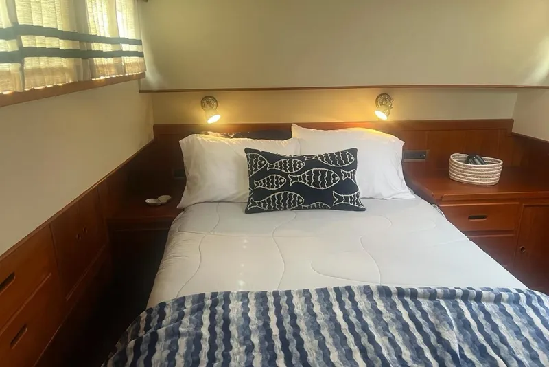 Slide: The Image of Cozy bedroom in 2000 Grand Banks 36 Classic yacht with nautical decor and wooden furnishings. - 19