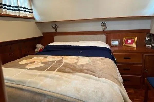 Slide: The Image of Cozy bedroom interior of 2000 Grand Banks 36 Classic yacht with wooden furnishings. - 20