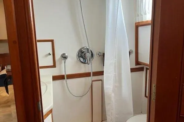 Slide: The Image of Bathroom interior of 2000 Grand Banks 36 Classic yacht, featuring shower and wooden accents. - 23