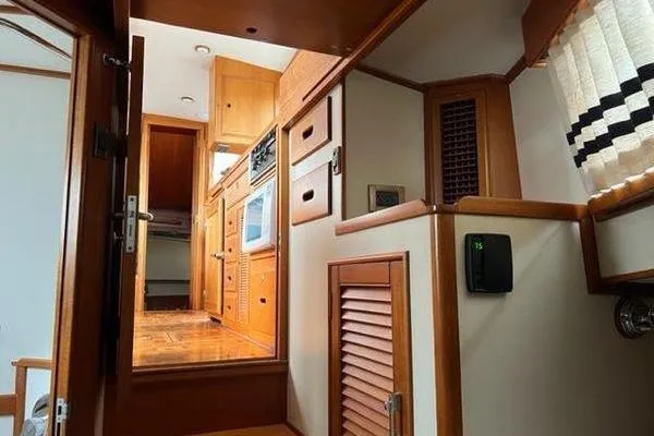 Slide: The Image of Interior of 2000 Grand Banks 36 Classic yacht, featuring wooden cabinetry and modern appliances. - 24