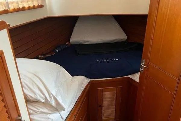 Slide: The Image of Cozy cabin interior of 2000 Grand Banks 36 Classic yacht with wooden paneling. - 26