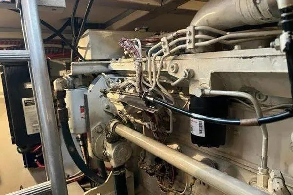 Slide: The Image of Engine room of 2000 Grand Banks 36 Classic yacht, showcasing mechanical components and wiring. - 33