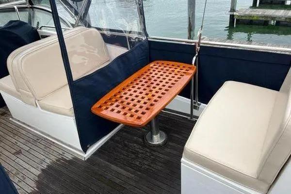 Slide: The Image of Grand Banks 36 Classic 2000 boat interior with wooden table and cushioned seating. - 5