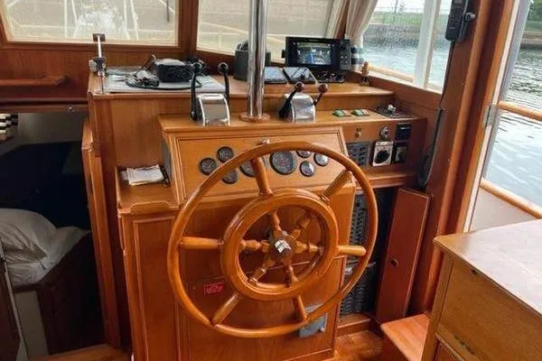 Slide: The Image of Helm of 2000 Grand Banks 36 Classic yacht with wooden steering wheel and navigation instruments. - 7