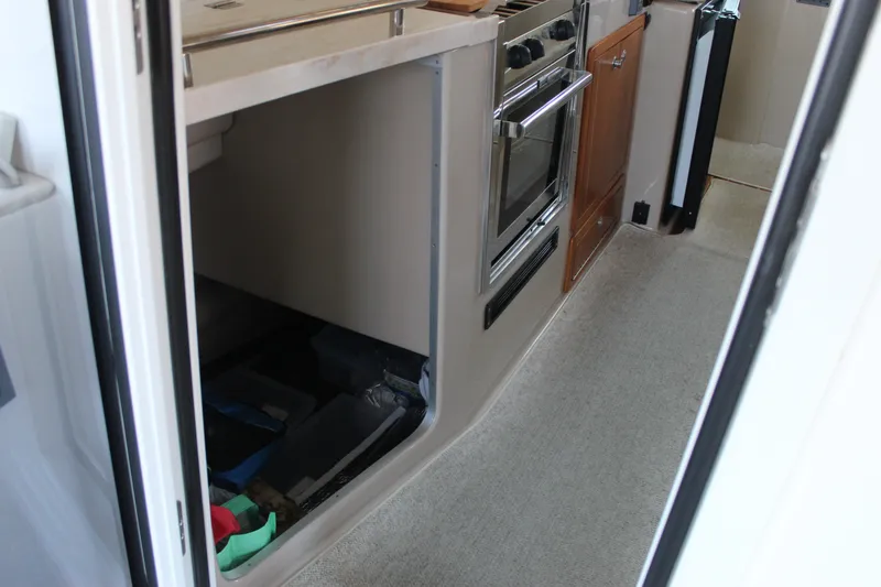 Slide: The Image of Compact kitchen area in 2016 Aspen B100 boat with oven and storage. - 15