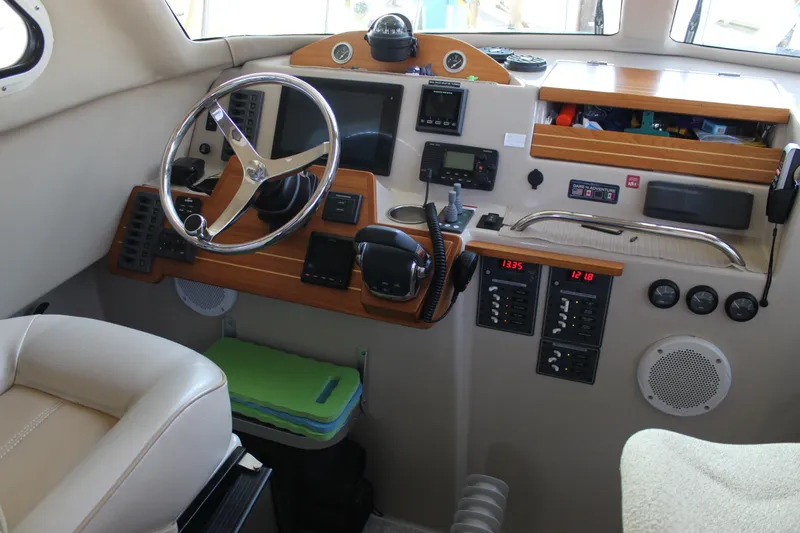 Slide: The Image of Interior of a 2016 Aspen B100 boat cockpit with steering wheel and control panels. - 18