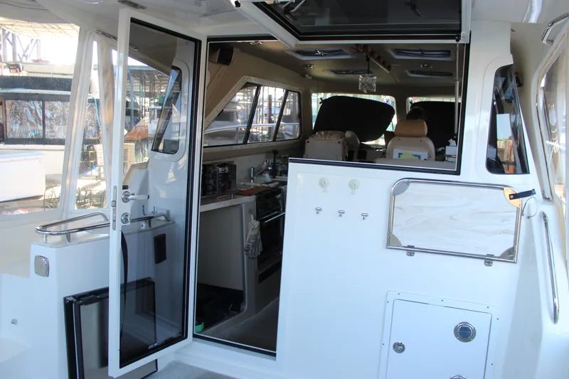 Slide: The Image of Interior view of 2016 Aspen B100 boat, featuring kitchen and seating area. - 21