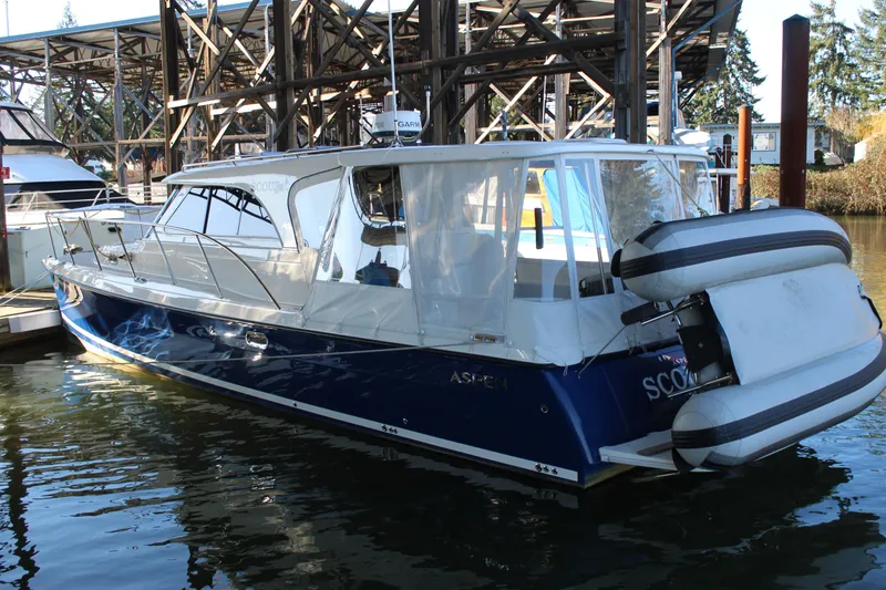 Slide: The Image of 2016 Aspen B100 boat docked with inflatable dinghy attached, in a marina setting. - 3