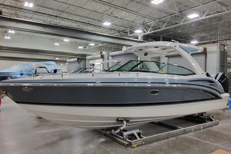 Slide: The Image of 2026 Formula 310 Bowrider OB boat in a showroom, side view. - 1