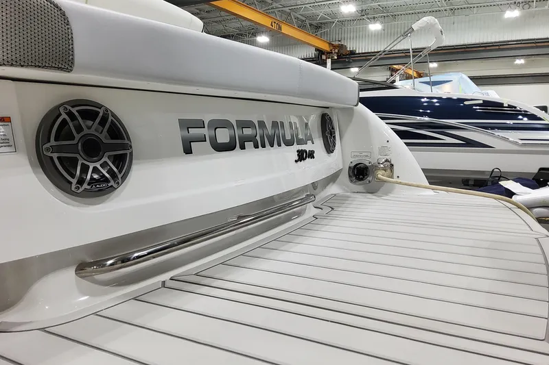 Slide: The Image of 2026 Formula 310 Bowrider OB boat in showroom, featuring sleek design and modern amenities. - 10