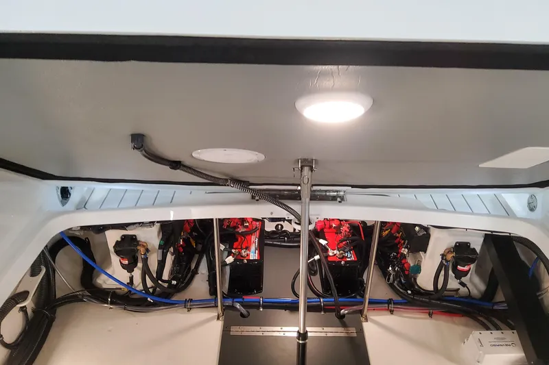 Slide: The Image of Interior view of 2026 Formula 310 Bowrider OB boat's engine compartment, showcasing wiring and components. - 101