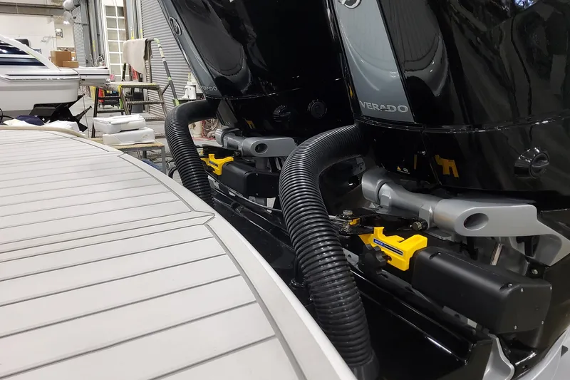 Slide: The Image of 2026 Formula 310 Bowrider OB with dual Verado outboard engines in a workshop setting. - 11