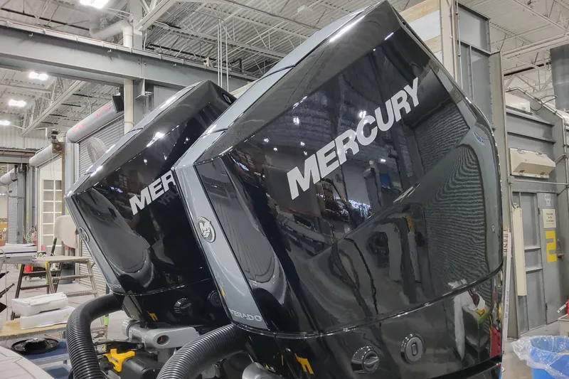 Slide: The Image of Twin Mercury outboard engines on a 2026 Formula 310 Bowrider OB in a workshop. - 12