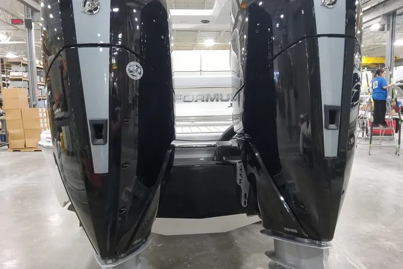 Slide: The Image of 2026 Formula 310 Bowrider OB with dual outboard engines in a factory setting. - 15