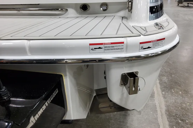 Slide: The Image of 2026 Formula 310 Bowrider OB boat stern with safety warnings and Armstrong bracket. - 17