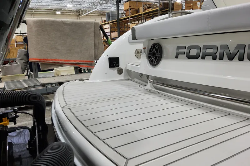 Slide: The Image of 2026 Formula 310 Bowrider OB boat in a manufacturing facility, showcasing sleek design. - 19