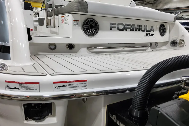 Slide: The Image of 2026 Formula 310 Bowrider OB boat, rear view with deck and branding. - 21