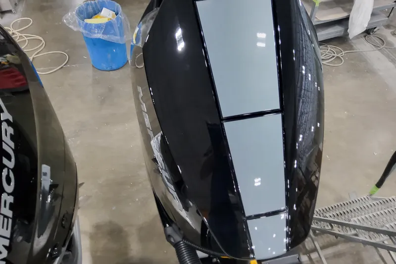 Slide: The Image of 2026 Formula 310 Bowrider OB with Mercury outboard engines in a workshop setting. - 23