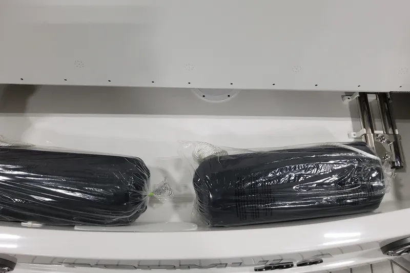 Slide: The Image of 2026 Formula 310 Bowrider OB storage compartment with packaged boat accessories. - 29