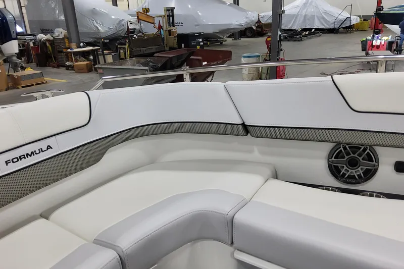 Slide: The Image of 2026 Formula 310 Bowrider OB interior with white seating and speaker in a workshop. - 36