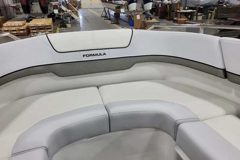 Slide: The Image of 2026 Formula 310 Bowrider OB boat interior with white cushioned seating. - 37