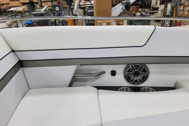 Slide: The Image of 2026 Formula 310 Bowrider OB interior with white seating, speaker, and cup holders. - 39