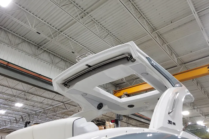 Slide: The Image of 2026 Formula 310 Bowrider OB boat in a warehouse, showcasing its sleek design and structure. - 4