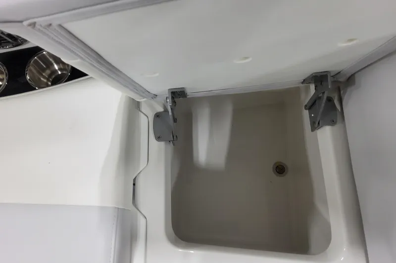 Slide: The Image of Storage compartment in 2026 Formula 310 Bowrider OB boat, featuring durable hinges and drain. - 42