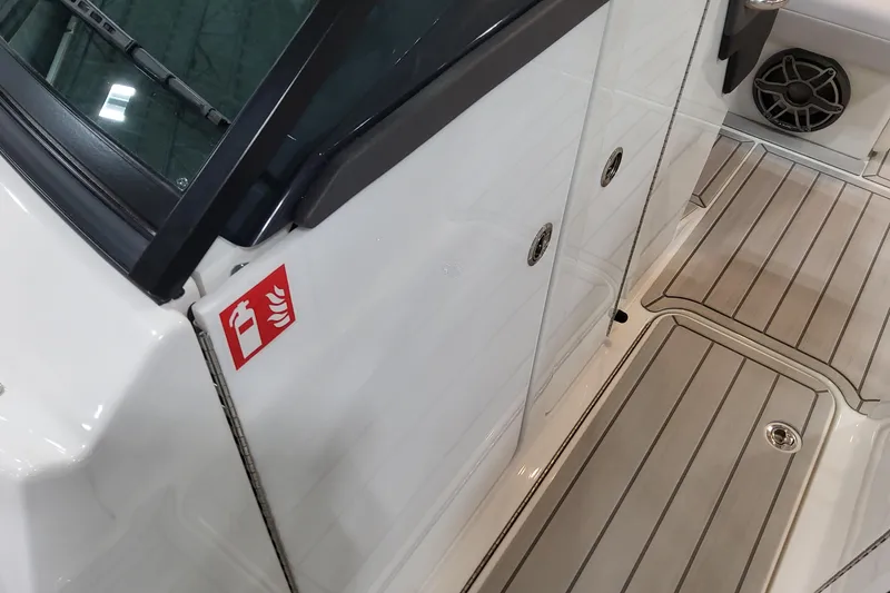 Slide: The Image of 2026 Formula 310 Bowrider OB boat interior with fire extinguisher sign and sleek flooring. - 44