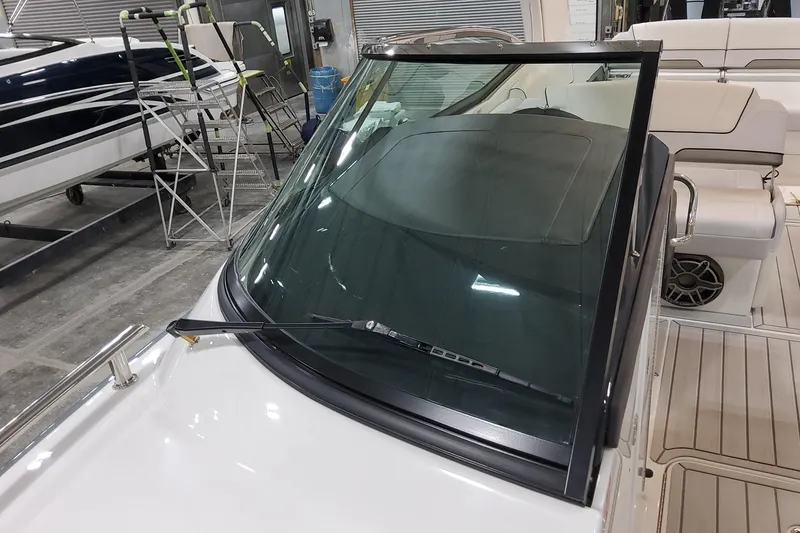 Slide: The Image of 2026 Formula 310 Bowrider OB boat interior with windshield and seating area. - 46