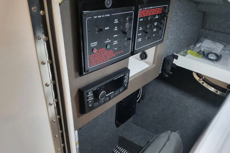 Slide: The Image of Control panel inside 2026 Formula 310 Bowrider OB boat cabin, featuring modern electronics. - 48