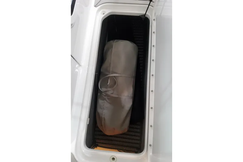 Slide: The Image of Storage compartment in 2026 Formula 310 Bowrider OB boat with a bag inside. - 52