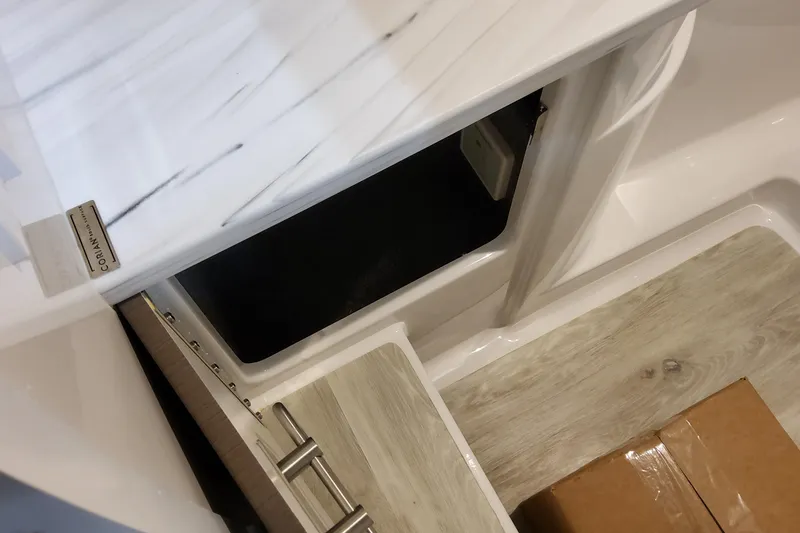 Slide: The Image of Interior view of 2026 Formula 310 Bowrider OB, featuring storage compartment and Corian countertop. - 63