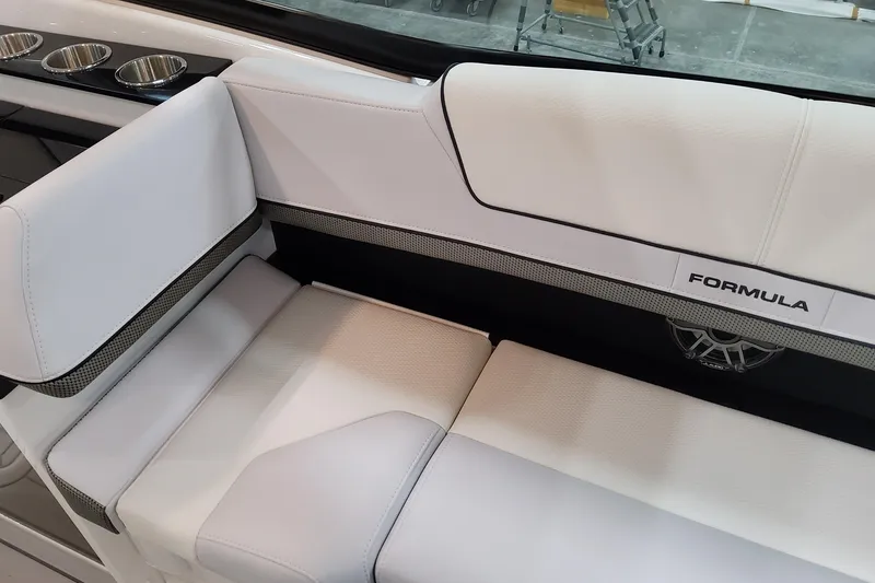 Slide: The Image of 2026 Formula 310 Bowrider OB interior seating with cup holders and branded upholstery. - 66