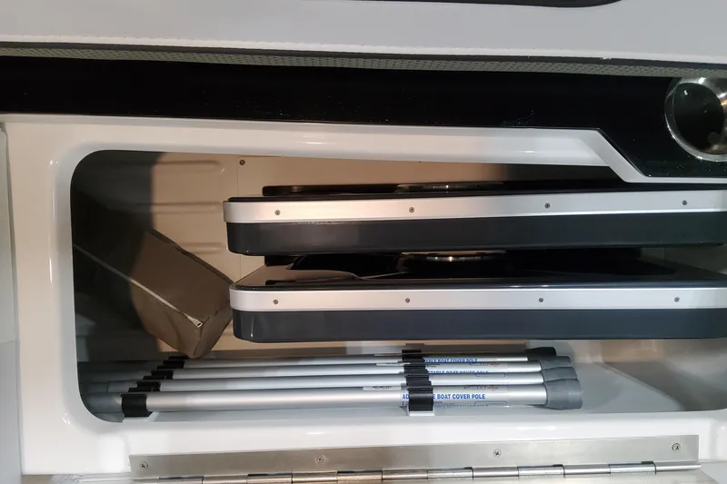 Slide: The Image of Storage compartment in 2026 Formula 310 Bowrider OB boat, featuring organized equipment and accessories. - 82