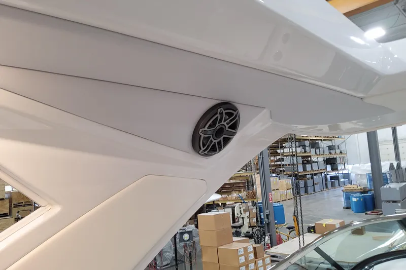Slide: The Image of 2026 Formula 310 Bowrider OB boat interior with speaker, in a warehouse setting. - 88