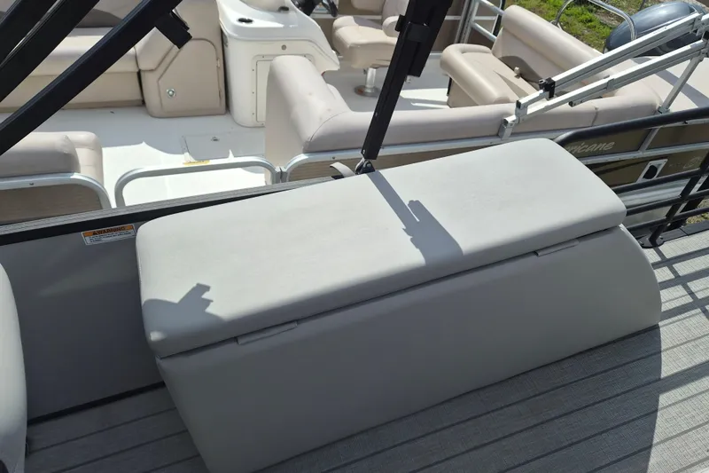 Slide: The Image of 2024 Sylvan L3 CLZ DH pontoon boat with beige seating and storage compartment. - 10