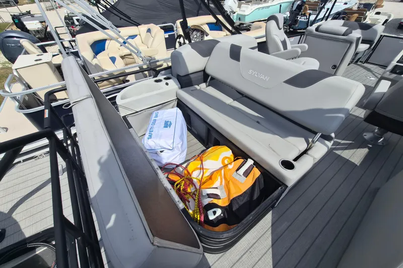 Slide: The Image of 2024 Sylvan L3 CLZ DH boat with open storage compartment, safety gear visible. - 13