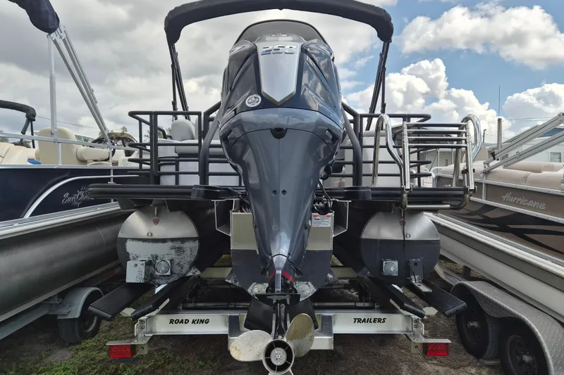 Slide: The Image of 2024 Sylvan L3 CLZ DH pontoon boat on trailer, rear view with outboard motor. - 3