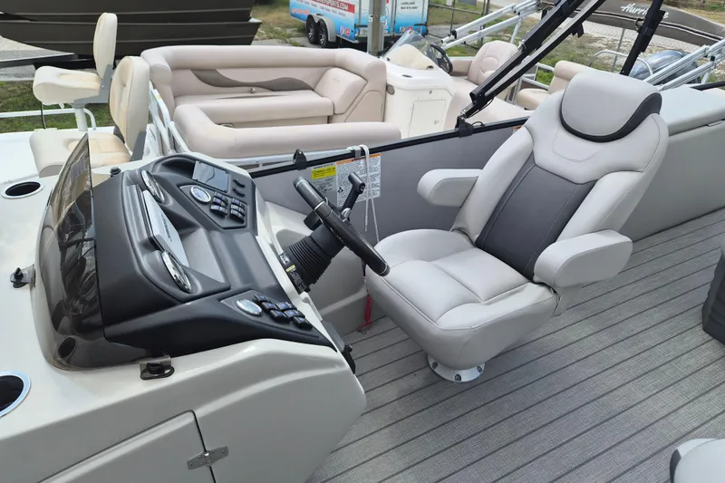 Slide: The Image of 2024 Sylvan L3 CLZ DH boat interior with modern helm and comfortable seating. - 6