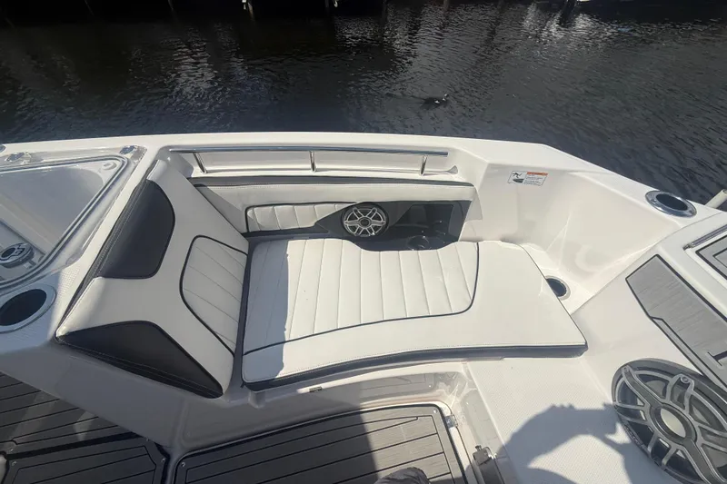 Slide: The Image of 2024 Yamaha Boats 255 FSH Sport H interior seating with sleek design and speaker system. - 12
