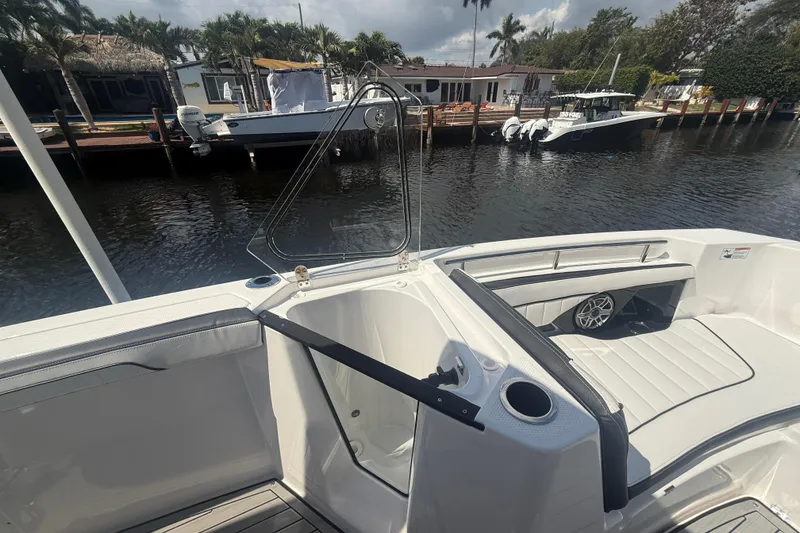 Slide: The Image of 2024 Yamaha Boats 255 FSH Sport H interior with seating and water view. - 15