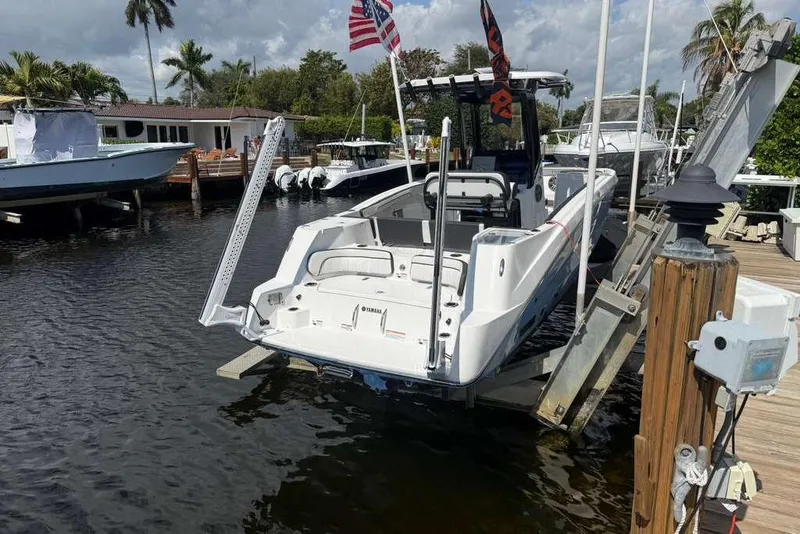 Slide: The Image of 2024 Yamaha Boats 255 FSH Sport H docked, featuring sleek design and modern amenities. - 2