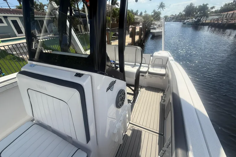 Slide: The Image of 2024 Yamaha Boats 255 FSH Sport H on a sunny canal, showcasing sleek interior design. - 20