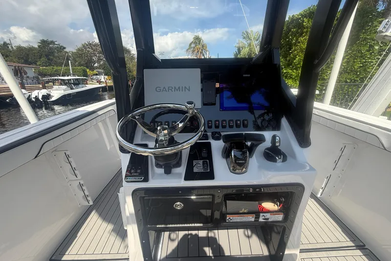 Slide: The Image of 2024 Yamaha Boats 255 FSH Sport H helm with Garmin navigation system and sleek controls. - 21