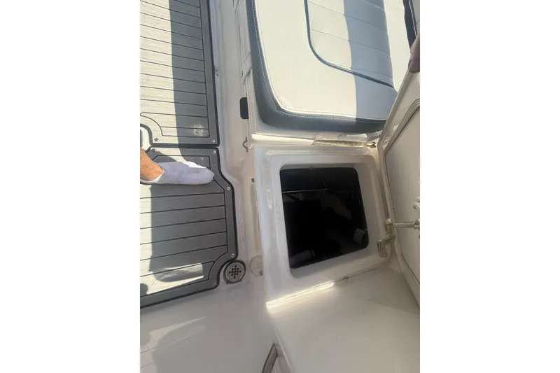 Slide: The Image of 2024 Yamaha Boats 255 FSH Sport H interior storage compartment with cushioned seating. - 24
