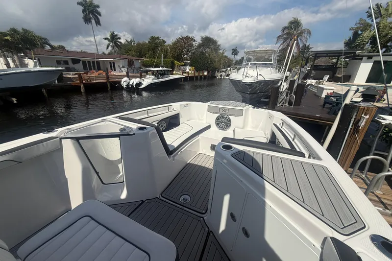 Slide: The Image of 2024 Yamaha Boats 255 FSH Sport H docked, showcasing spacious seating and sleek design. - 6